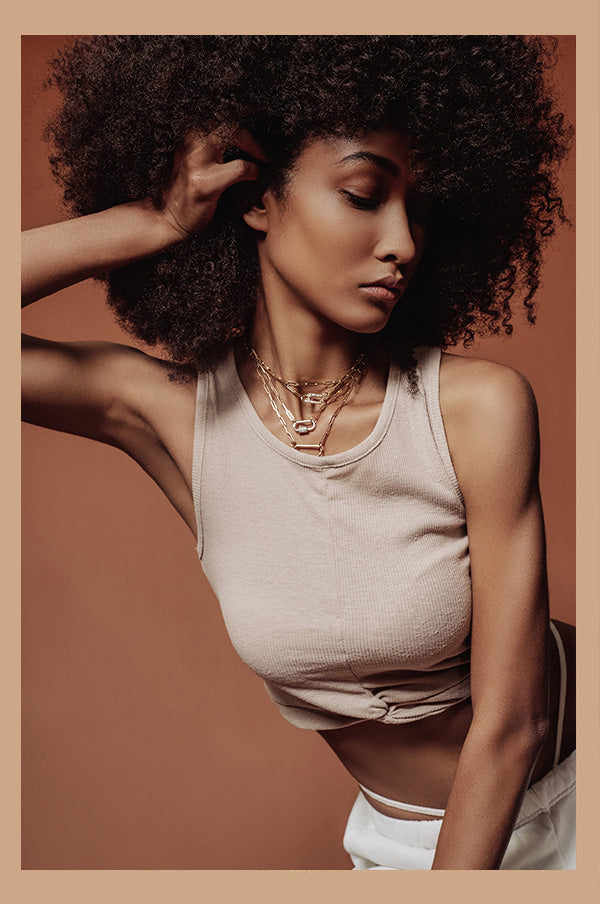 Girl wearing layered gold necklaces